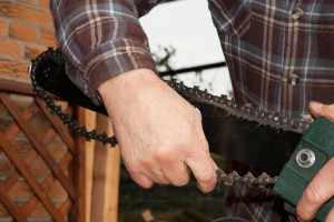 Man sharpening a chainsaw chain